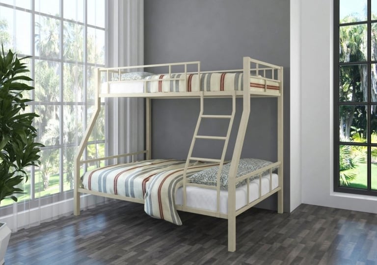 Wooden bunk bed with striped mattresses in a bright room with large windows and potted plants